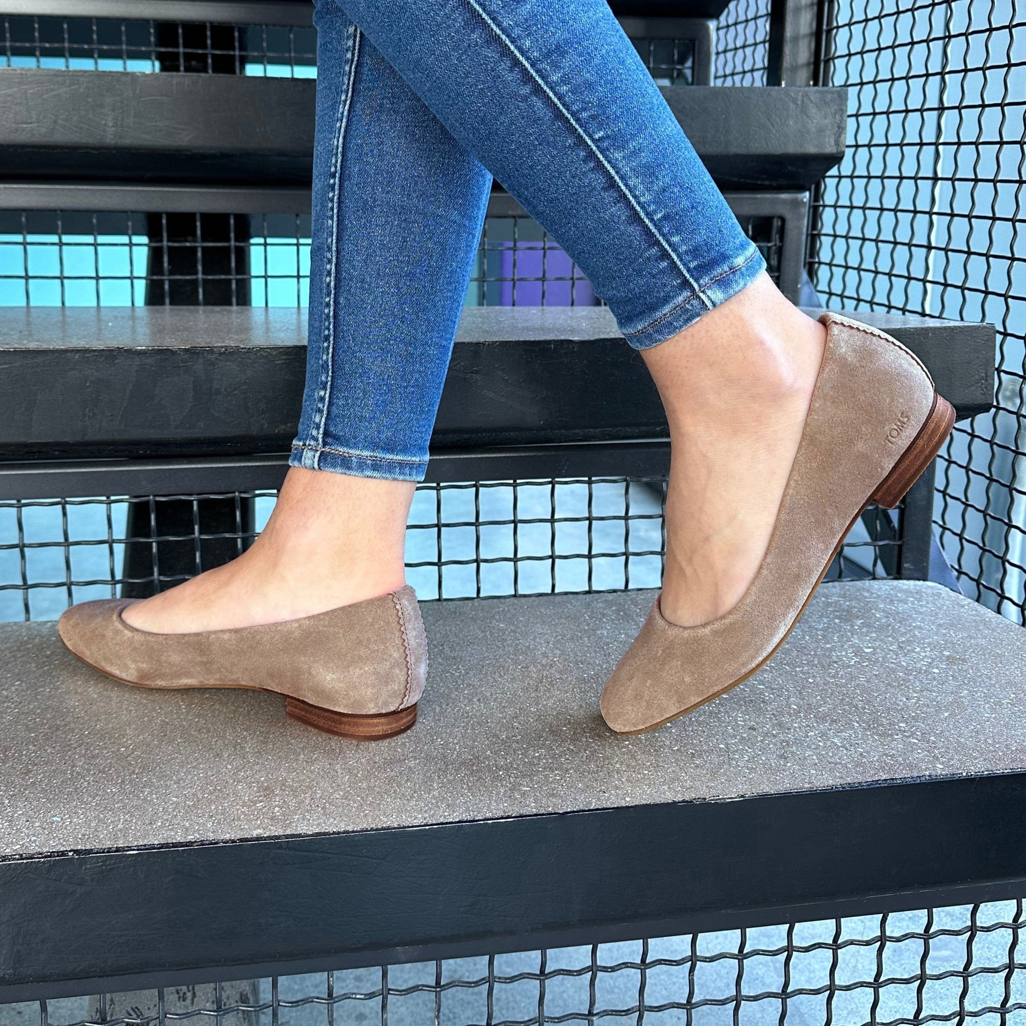 Briella Ballet Flat In Taupe Suede On Model Up Close Standing On Stairs