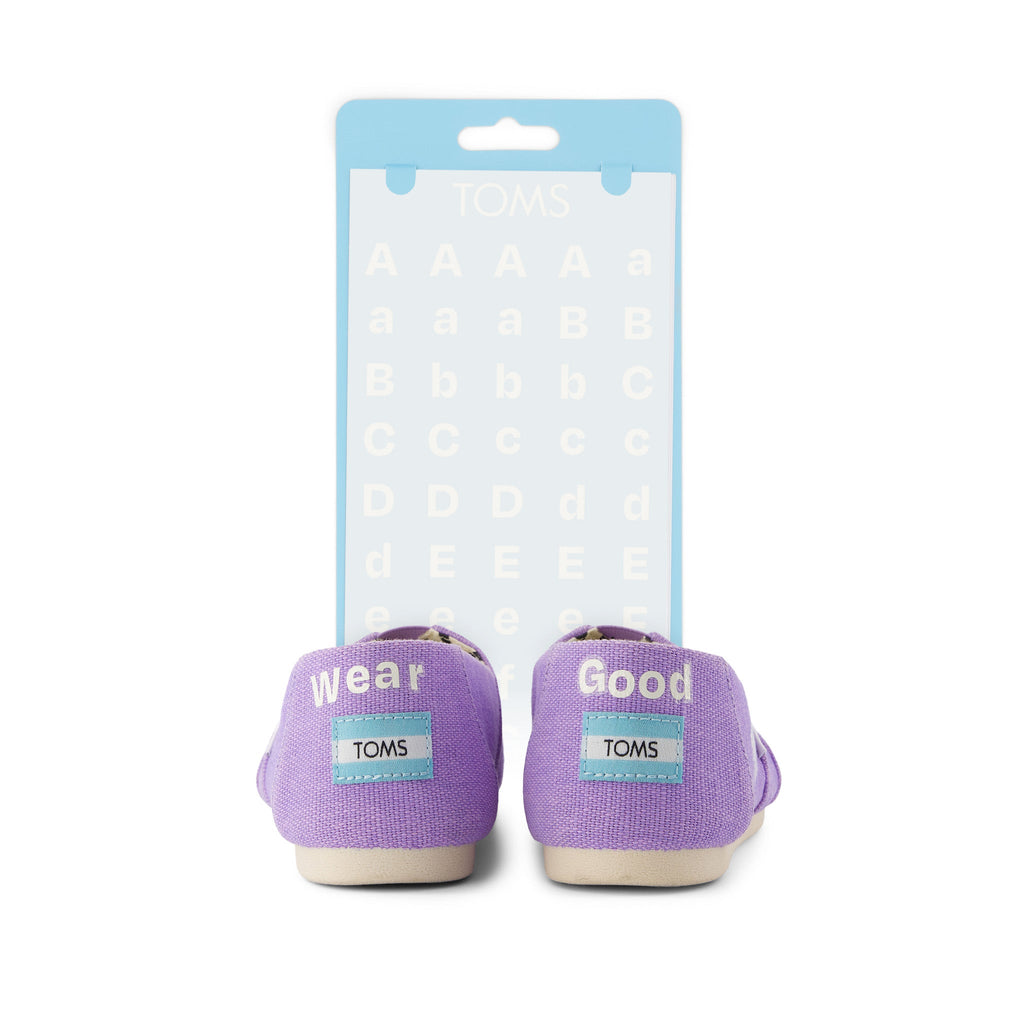 toms shoe tattoo white letters shown on purple shoe