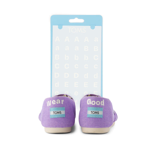 toms shoe tattoo white letters shown on purple shoe