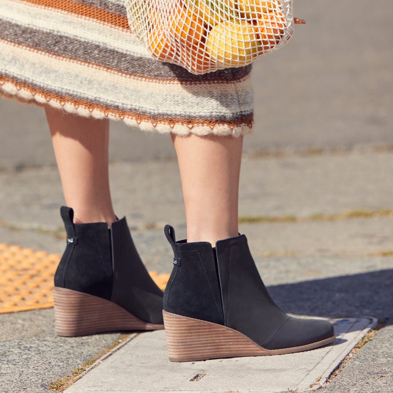 clare wedge boot in black leather suede combo on model close up detail shot