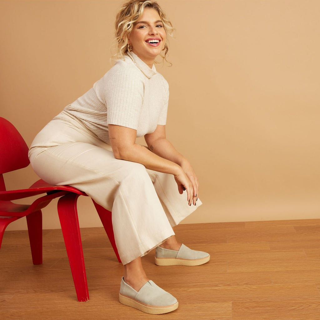 adalaide slip on casual shoe in clay suede on model sitting in chair