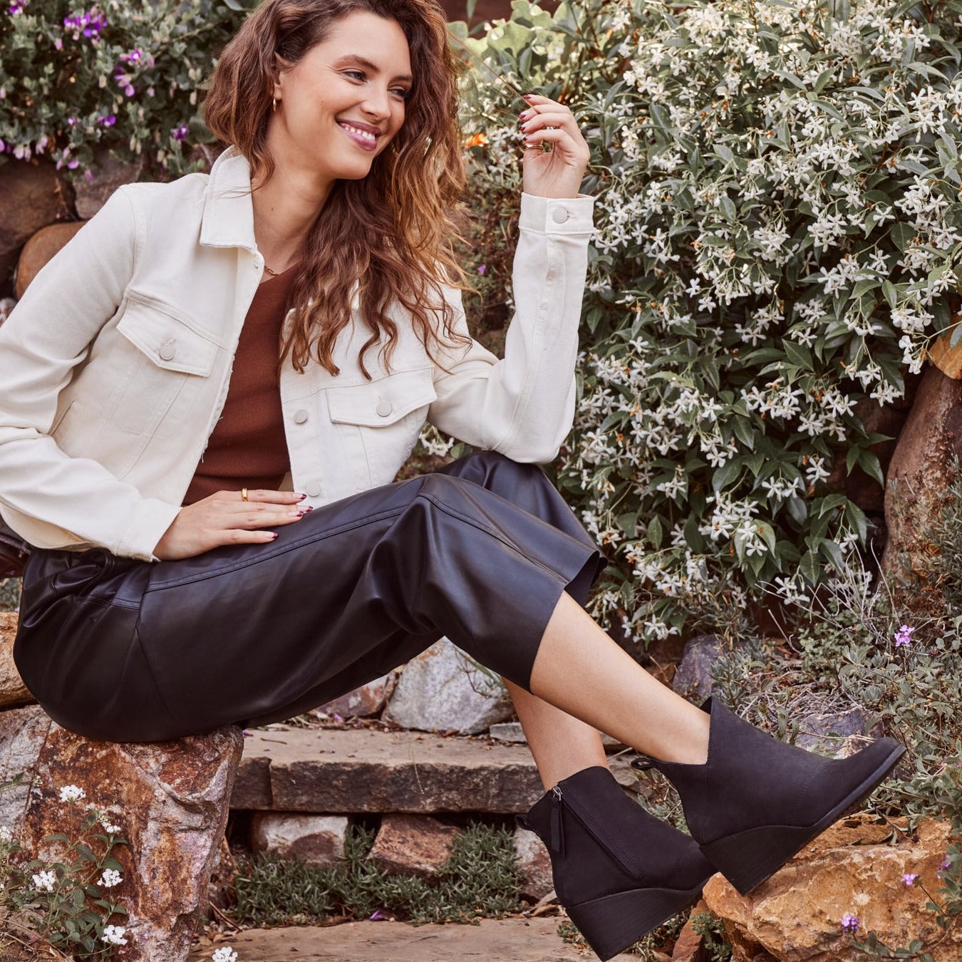 sutton wedge ankle boot in black leather on model sitting in garden