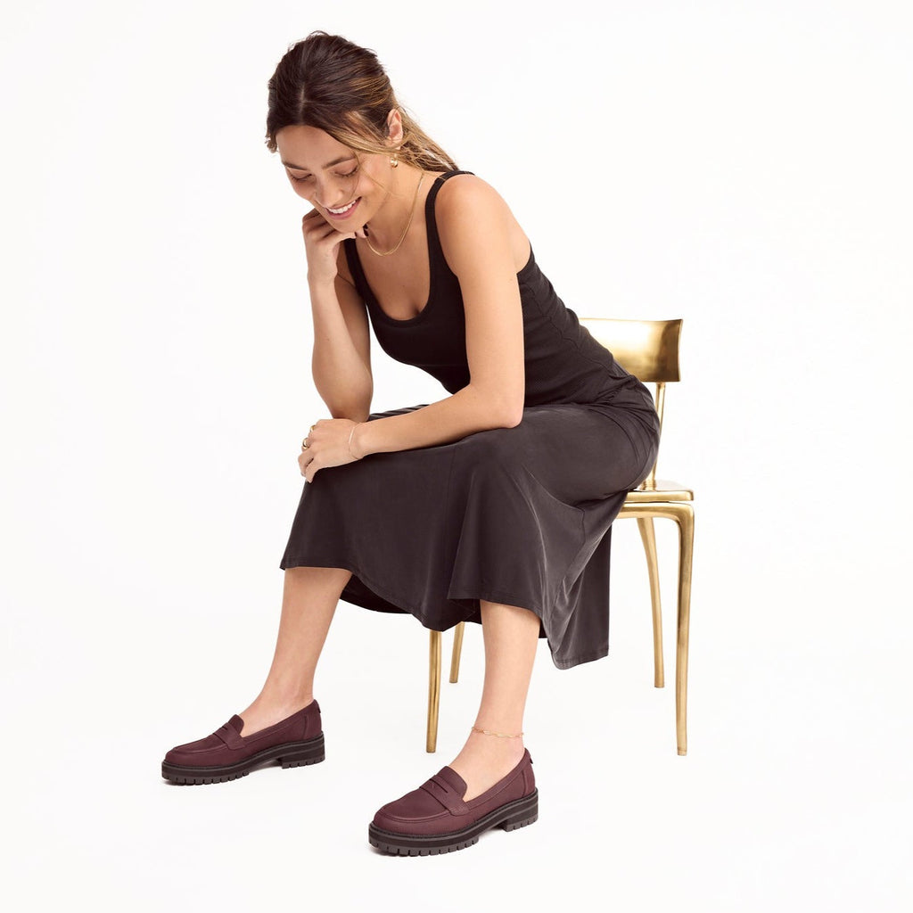 cara mule in blackberry leather lug loafer on model seated on chair
