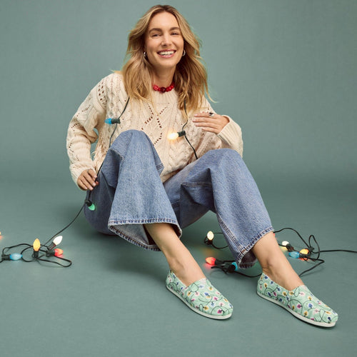 Lifestyle image of the winter green glow in the dark holiday lights alpargata