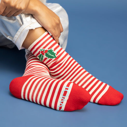 lifestyle shot holiday crew sock featuring candy cane print
