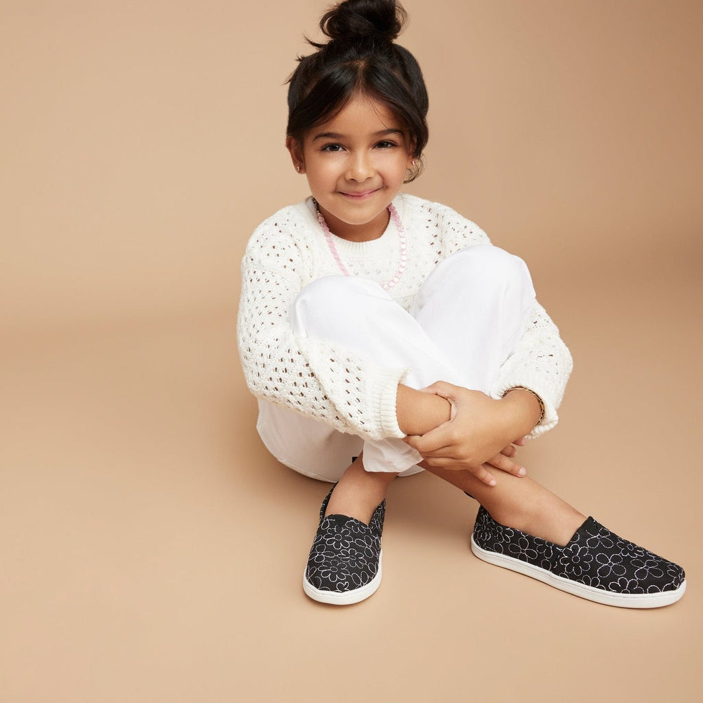 alpargata quilted daisy in black on school age model up close detail shot