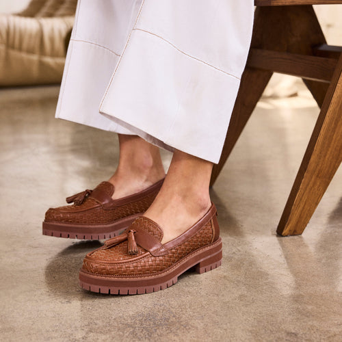 Up close on figure image of the amber brown faux leather tassel Cara loafer