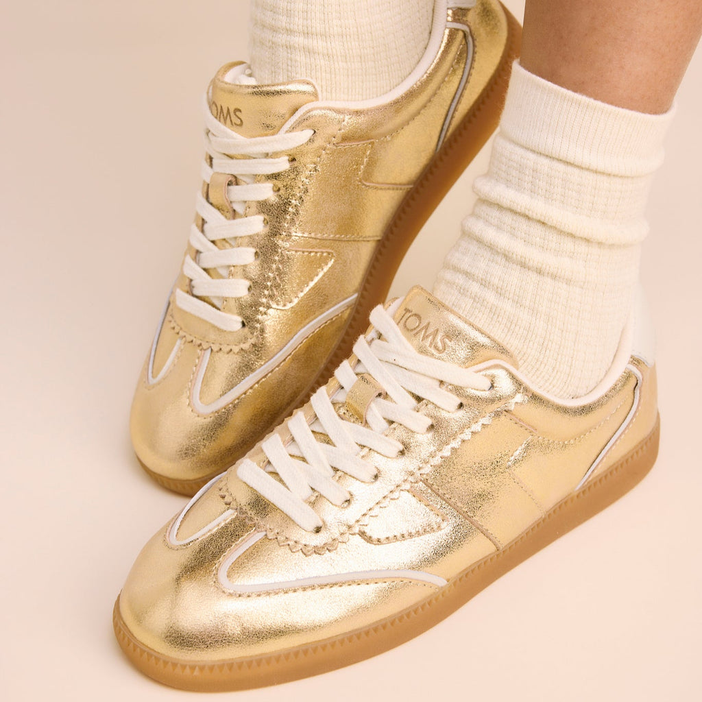 On figure image of the gold metallic leather sneakers