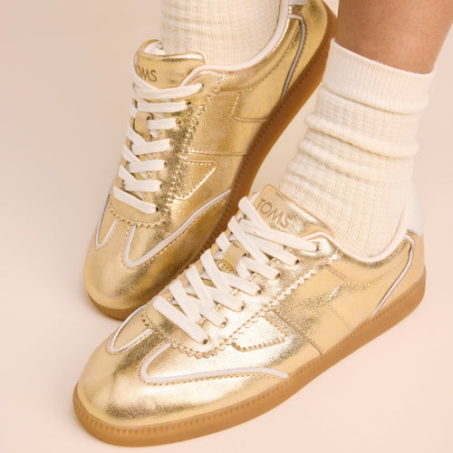 On figure image of the gold metallic leather sneakers