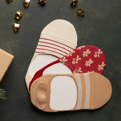 lifestyle shot of holiday socks featuring gingerbread cookie printed socks