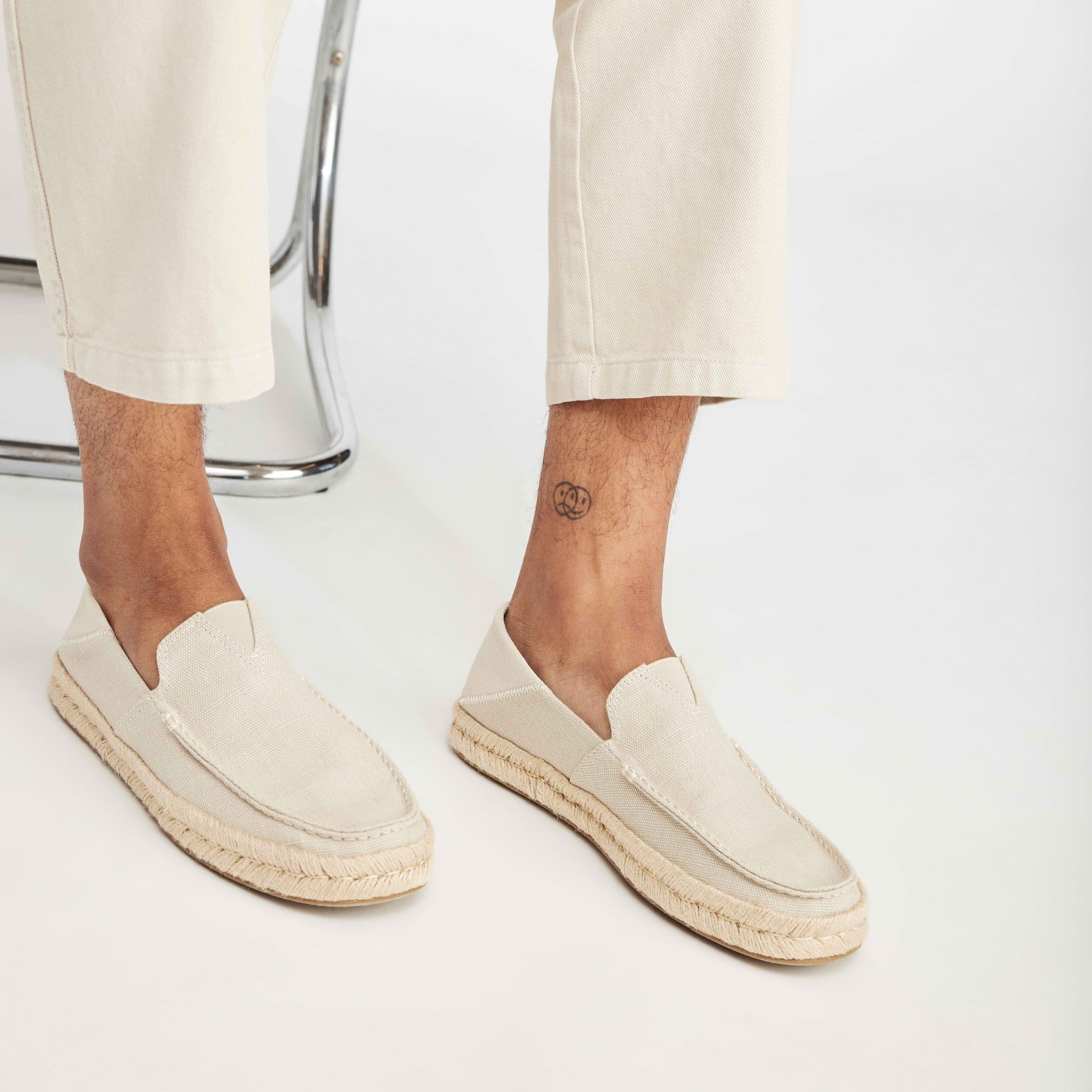 Alonso Loafer Up Close On Model Shot Wearing Natural Pants That Match Natural Canvas Loafer