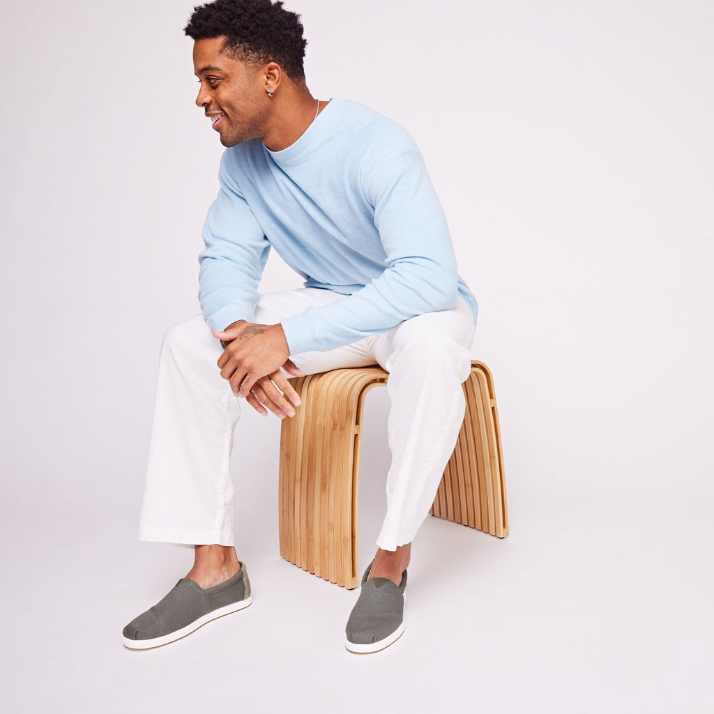 Alp Fwd Slip On Shoe In Sage Green On Model Sitting On Stool