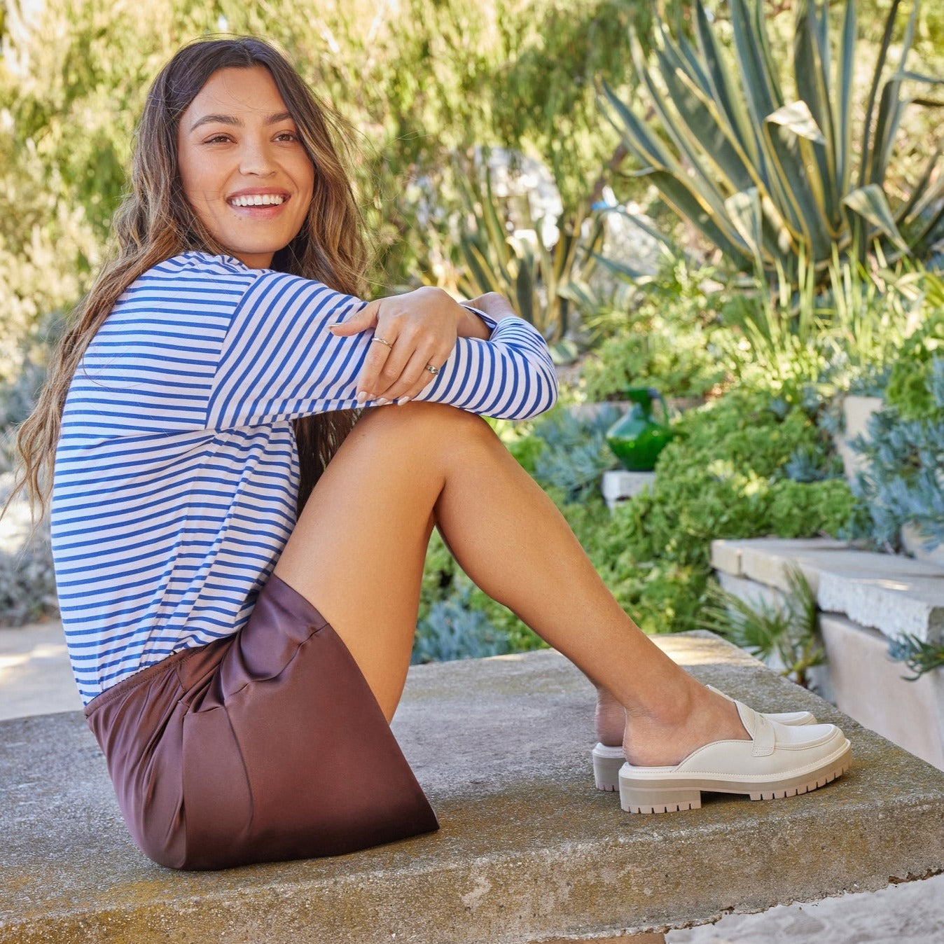 cara mule loafer in sand on model relaxing in nature