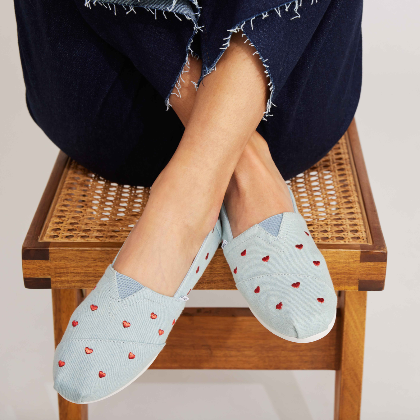 Alpargata In Light Denim With Embroidered Red Heart Pattern Up Close On Model