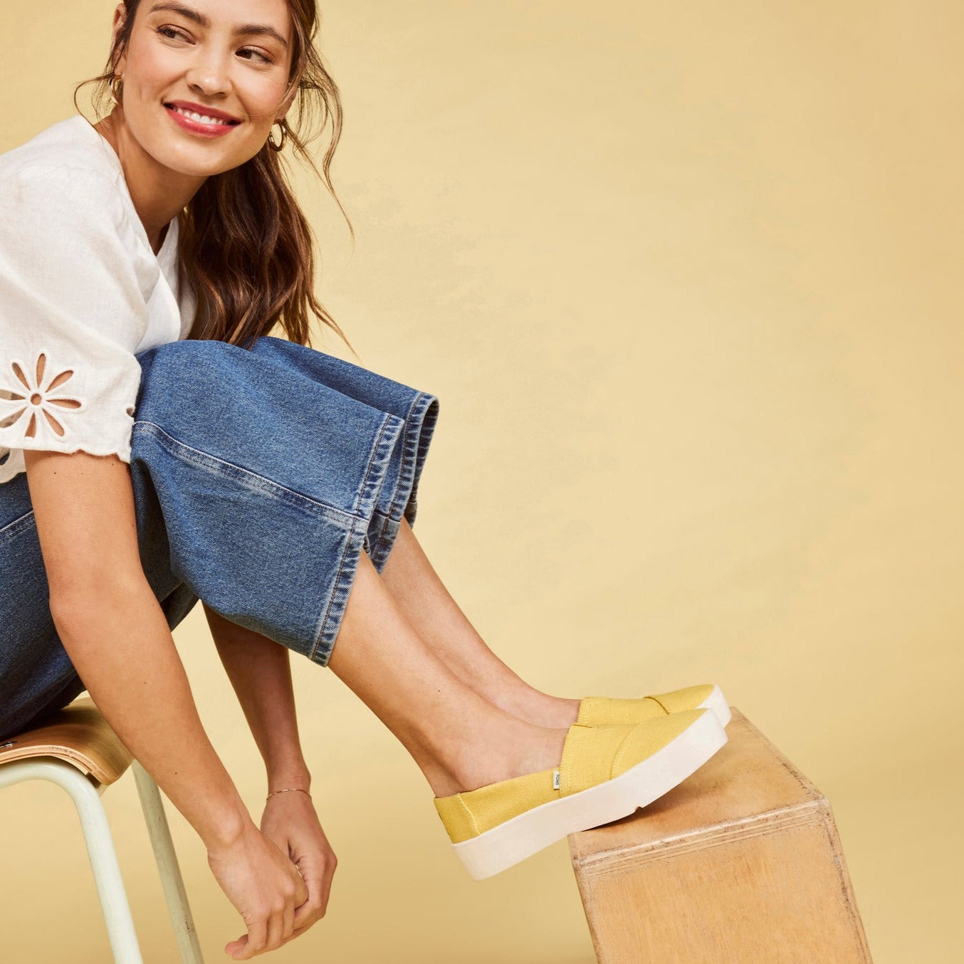 Verona Sneaker Slip On In Yellow Canvas On Model Sitting On Chair