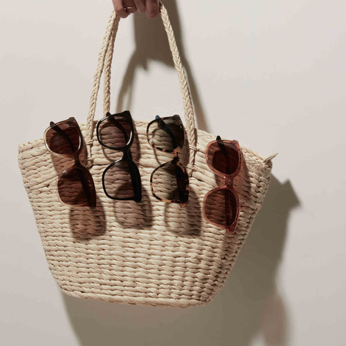 charmaine sunglasses in four colors detail shot on raffia handbag
