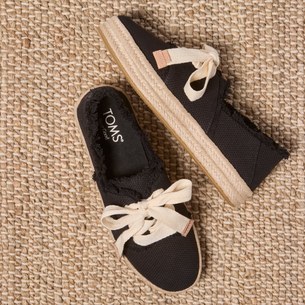 Laydown image of the black beachside woven lace up Carolina Espadrille