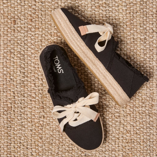 Laydown image of the black beachside woven lace up Carolina Espadrille