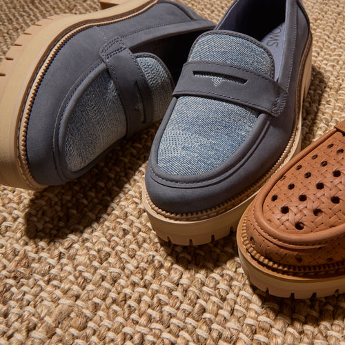 Laydown image of the blue sky denim and leather Cara loafer