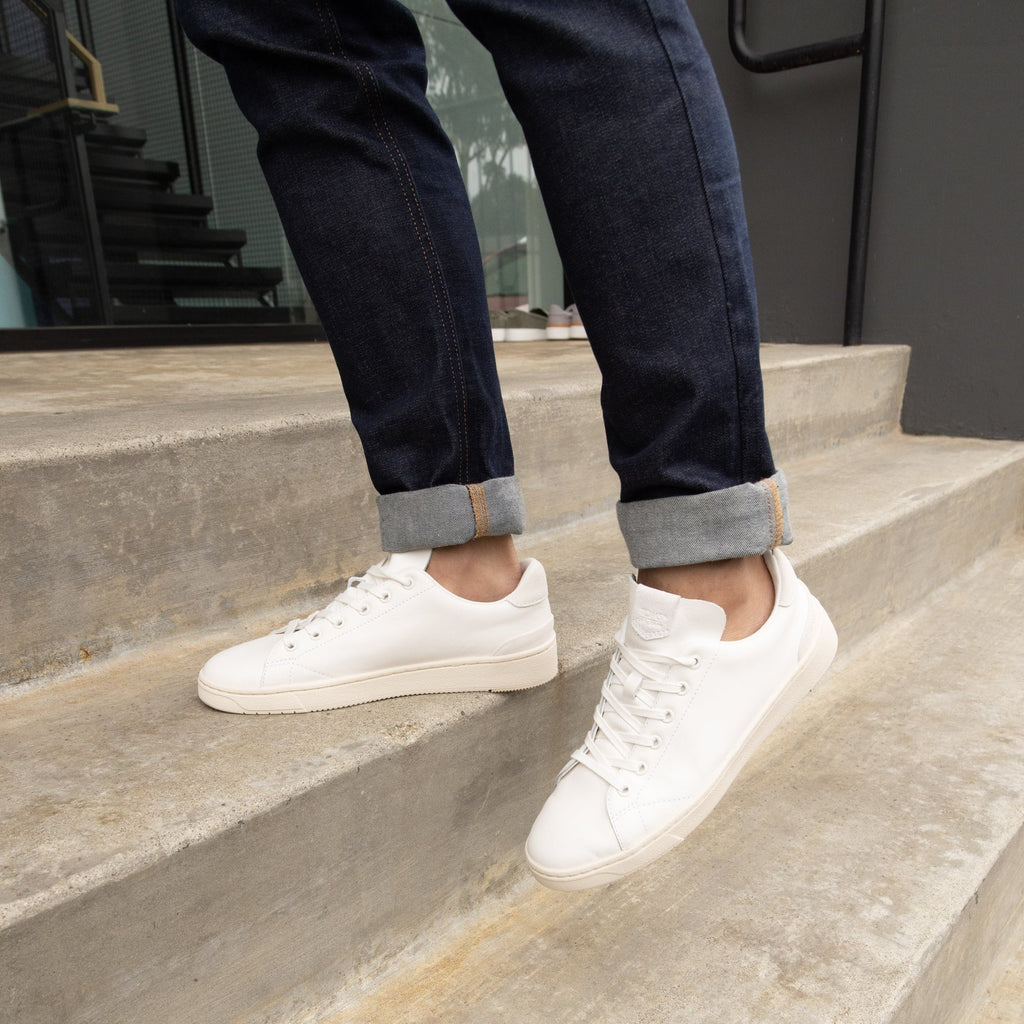 Trvl Lite Lace Up Sneaker In White Leather On Model Walking Up Stairs