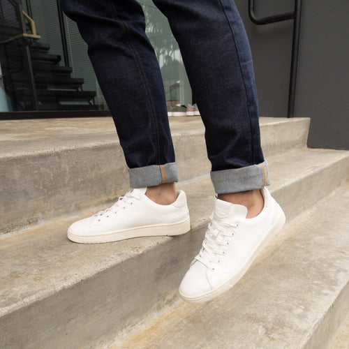 Trvl Lite Lace Up Sneaker In White Leather On Model Walking Up Stairs