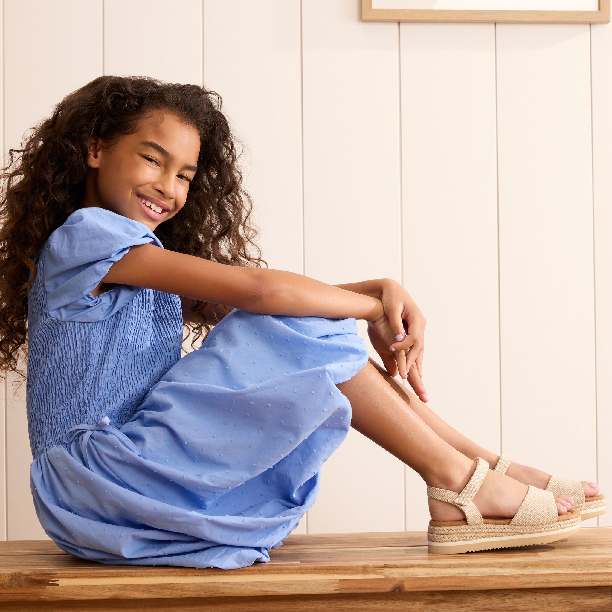 On model image of the champagne glimmer Kids Diana sandal 