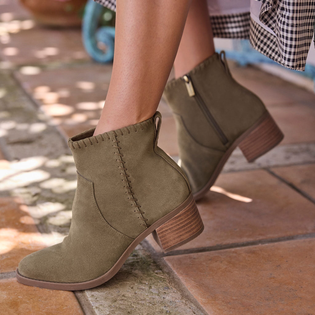 On figure image of olive green Delilah heeled boot