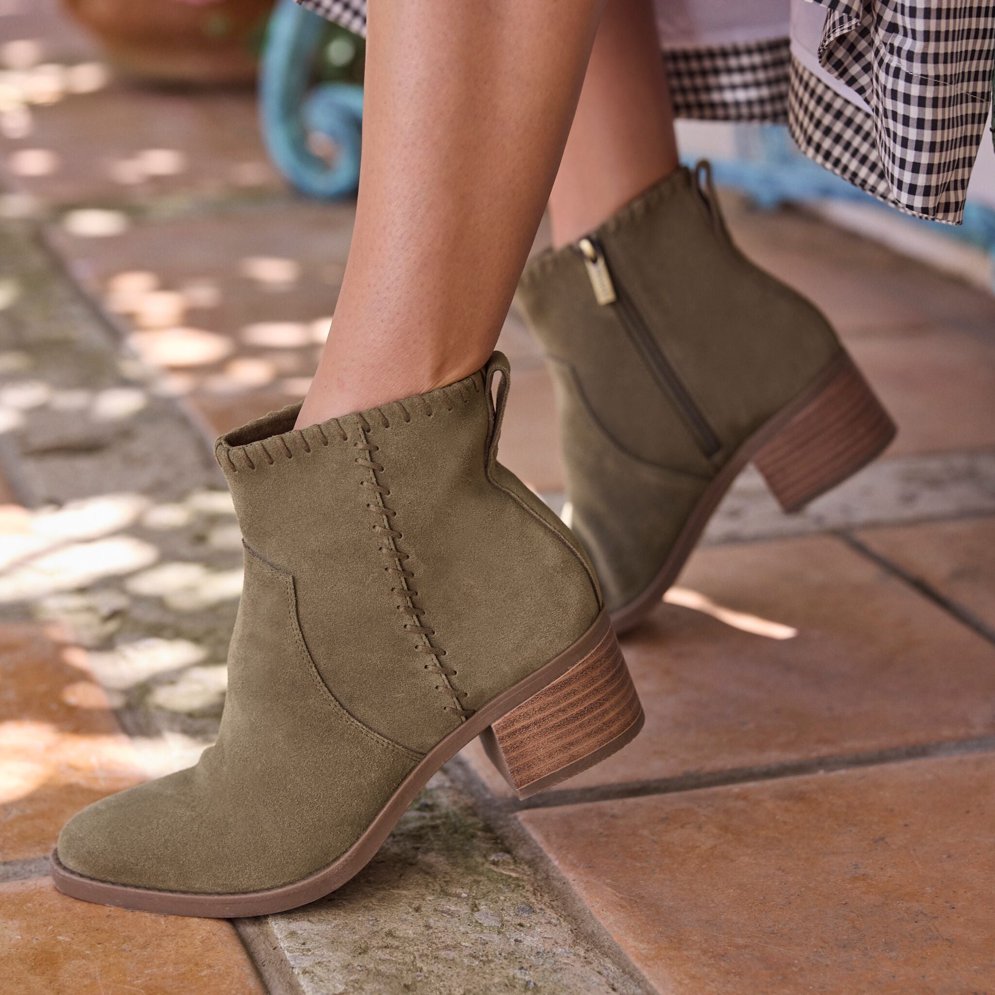 On figure image of olive green Delilah heeled boot